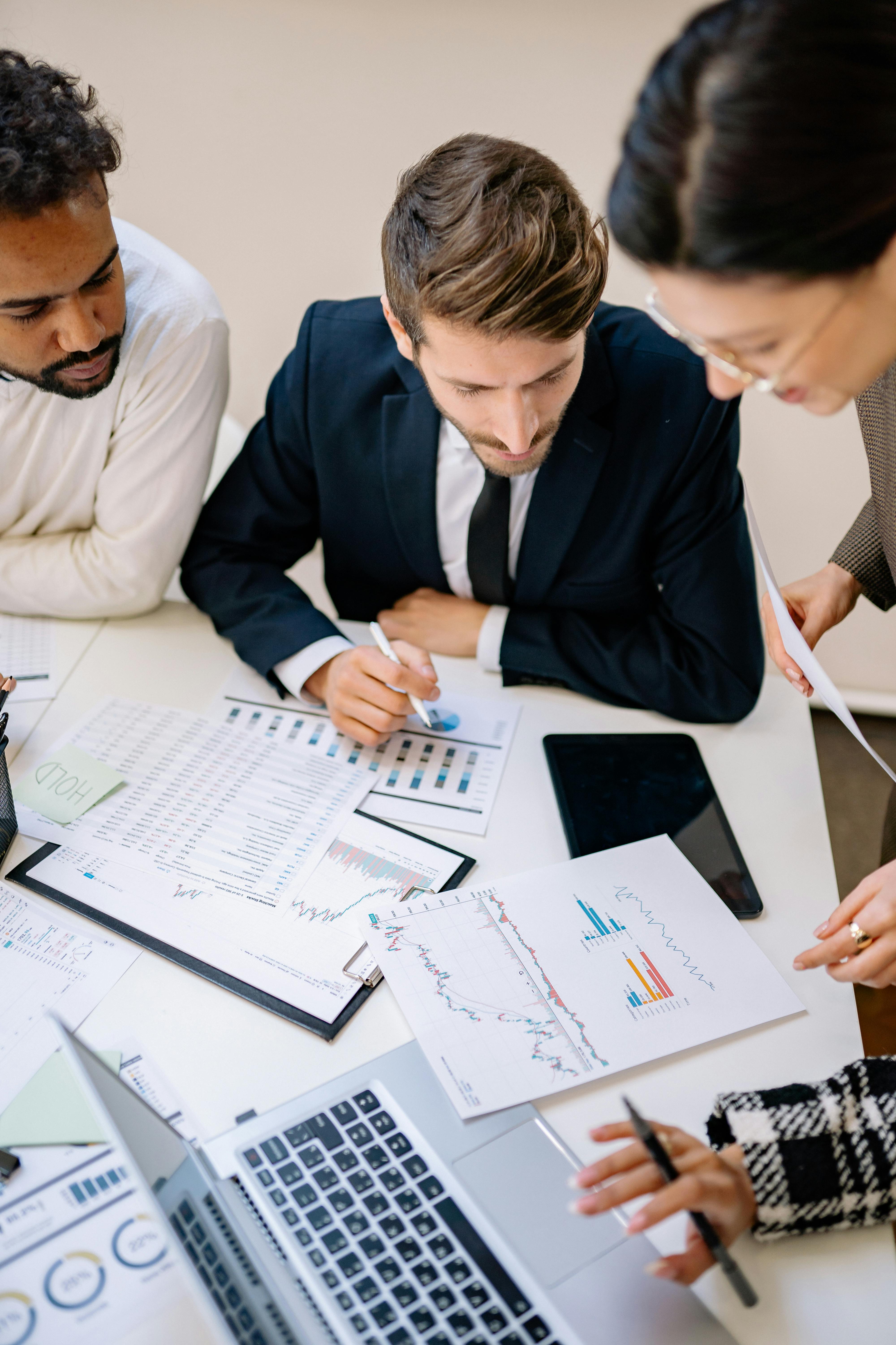 Investment team reviewing financial charts and projections